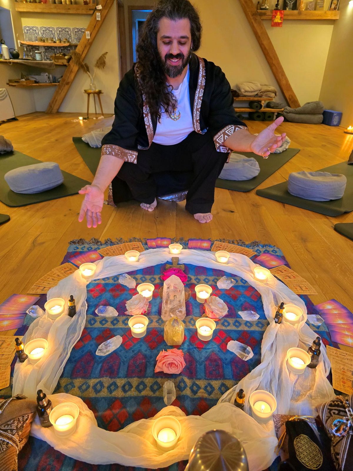 A candlelit altar of crystals and flowers set for a Blue Lotus ceremony.