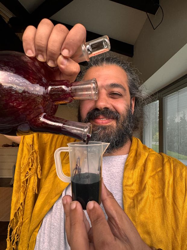 Ali making Blue Lotus elixir by hand in the lab